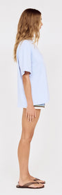 Relaxed Fit El Sol Print Tee in Pastel Blue side view on model, showcasing relaxed silhouette and soft cotton fabric.