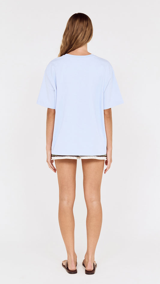 Relaxed Fit El Sol Print Tee in Pastel Blue worn from behind, featuring a soft light blue color and relaxed silhouette.