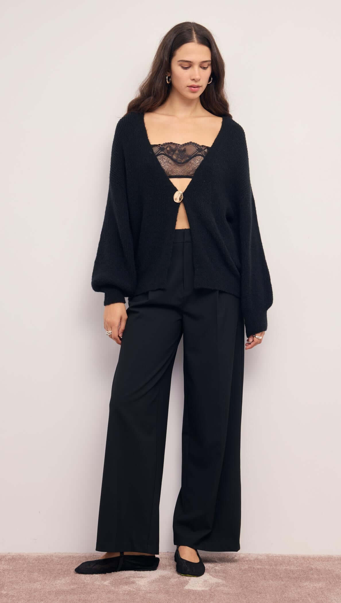 Relaxed Open Black Cardigan With Gold Closure styled with black pants and lace top.