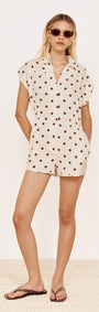 Model wearing a Relaxed Fit Playsuit in Chocolate Spot with a collared neckline and cap sleeves.