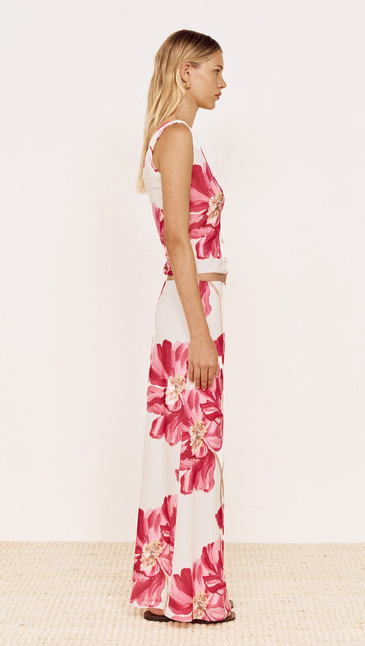 Model wearing Pink Floral Mesh Top with Low Back paired with coordinating floral skirt, showcasing side view.