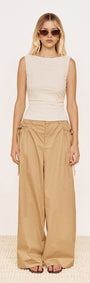Model wearing a Boat Neck Rib Detail Mesh Top in Cream paired with loose beige trousers and sunglasses.