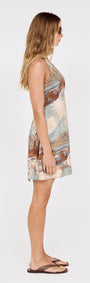 Side view of Island Print Halterneck Mini Dress showcasing scenic print and fitted A-line silhouette.