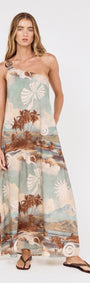 Model wearing the Island Print One Shoulder Maxi Dress featuring scenic island print and floor-grazing hem.