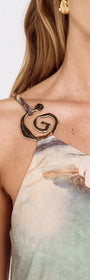 Close-up of the spiral clasp detail on the Island Print One Shoulder Maxi Dress.