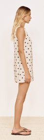 Gold Detail Keyhole Mini Dress in Chocolate Spot worn by a model, showcasing cream fabric with chocolate spots.