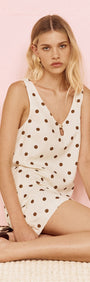 Gold Detail Keyhole Mini Dress in Chocolate Spot worn by model, showcasing cream and chocolate spot print.