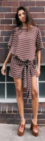 Model wearing a Striped Tie Waist Jersey Mini Dress with chocolate stripe print, featuring a relaxed style and adjustable tie at the waist.