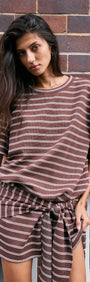 Model wearing a Striped Tie Waist Jersey Mini Dress featuring chocolate stripes and a relaxed fit.