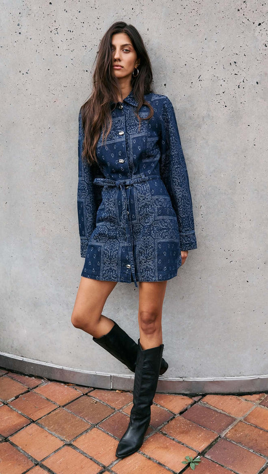 Model wearing a Paisley Jacquard Denim Shirt Dress with a collared neckline and waist tie, styled with knee-high boots.