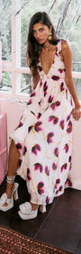 Model wearing Floral Ruffle Detail Bias Maxi Dress with blurred floral print in a stylish setting.