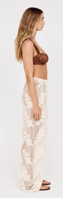 Model wearing Embroidered Net Relaxed Beach Pant with floral embroidery, showcasing a side profile against a plain background.