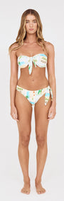 Model wearing Island Postcard Low Rise Knotted Bikini Bottom featuring side knot detail and postcard-inspired print.