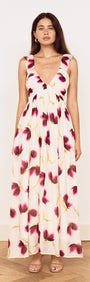 A model showcasing a Floral Ruffle Detail Bias Maxi Dress with a floral print in berry and golden tones.