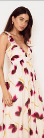 Floral Ruffle Detail Bias Maxi Dress displayed on a model with a blurred floral print in berry and golden colors.