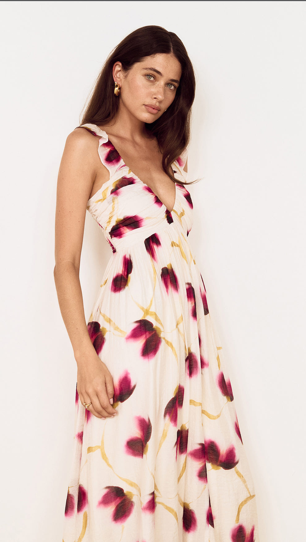 Floral Ruffle Detail Bias Maxi Dress displayed on a model with a blurred floral print in berry and golden colors.