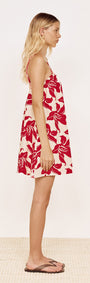 Cotton A-Line Mini Dress in Red Floral worn by a model from the side, featuring a bold floral print and relaxed fit.