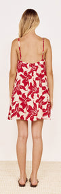 Cotton A-Line Mini Dress in Red Floral worn by a model, showcasing the back view and vibrant floral design.