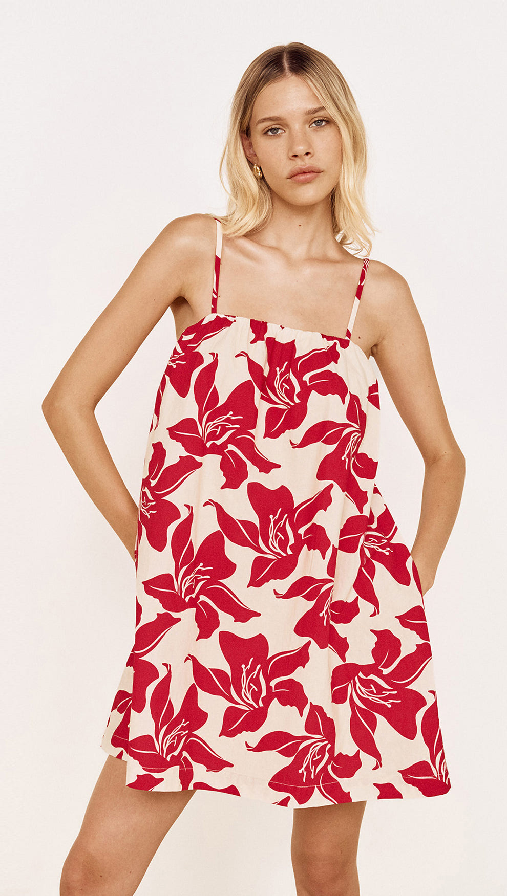 Cotton A-Line Mini Dress in Red Floral featuring a bold red floral print and adjustable tie shoulder straps.