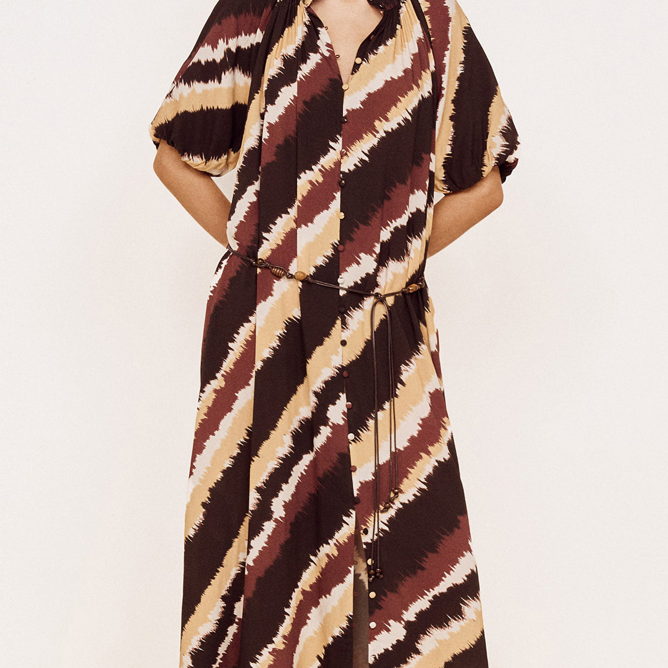 Puff Sleeve Belted Shirt Dress in Abstract Stripe worn by a model, featuring diagonal stripe print in chocolate, burgundy and neutrals.