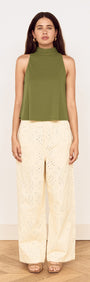 Model wearing a Green High Neck Jersey Top paired with light-colored wide-leg pants.