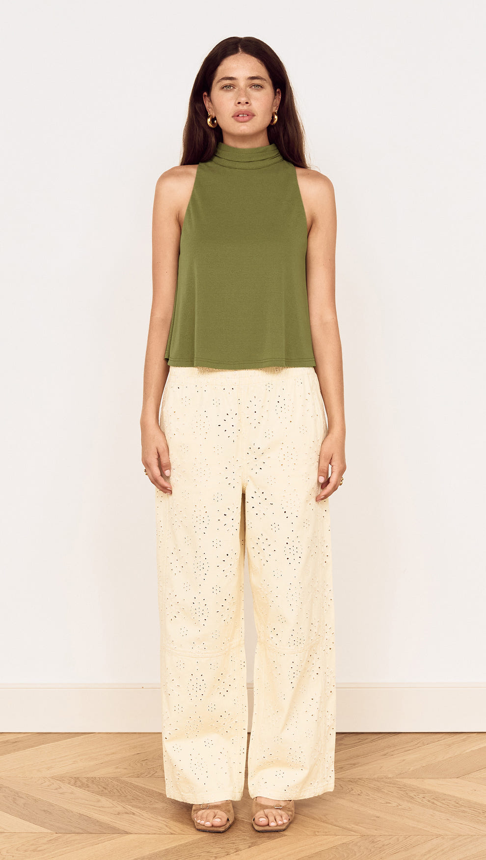 Model wearing a Green High Neck Jersey Top paired with light-colored wide-leg pants.