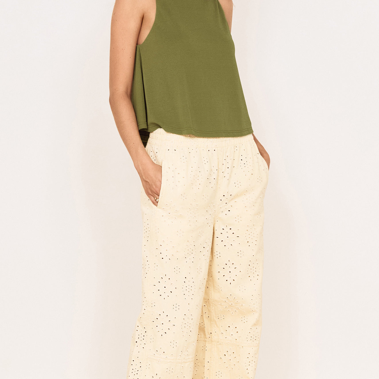 Model wearing a Green High Neck Jersey Top paired with light-colored pants, showcasing a stylish, relaxed outfit.