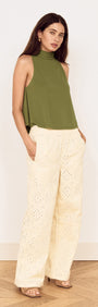 Model wearing a Green High Neck Jersey Top paired with light-colored pants, showcasing a stylish, relaxed outfit.