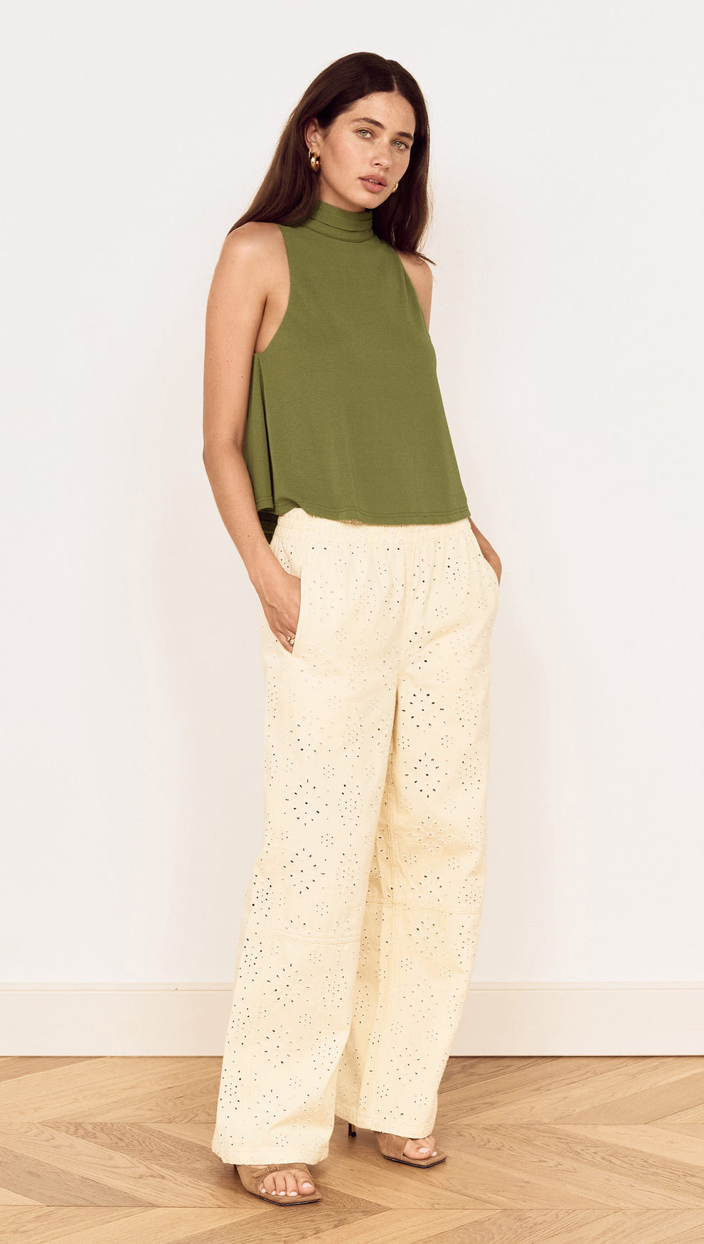 Model wearing a Green High Neck Jersey Top paired with light-colored pants, showcasing a stylish, relaxed outfit.
