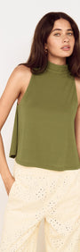 Green High Neck Jersey Top worn by a model with relaxed fit and high neckline, styled with light-colored pants.