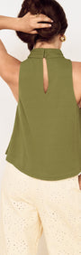 Back view of the Green High Neck Jersey Top with a keyhole detail, styled with light-colored pants.