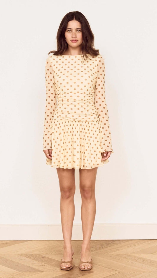 Butter Yellow Polka Dot Mini Dress with Drop Waist on a model, featuring long sleeves and a flared skirt.