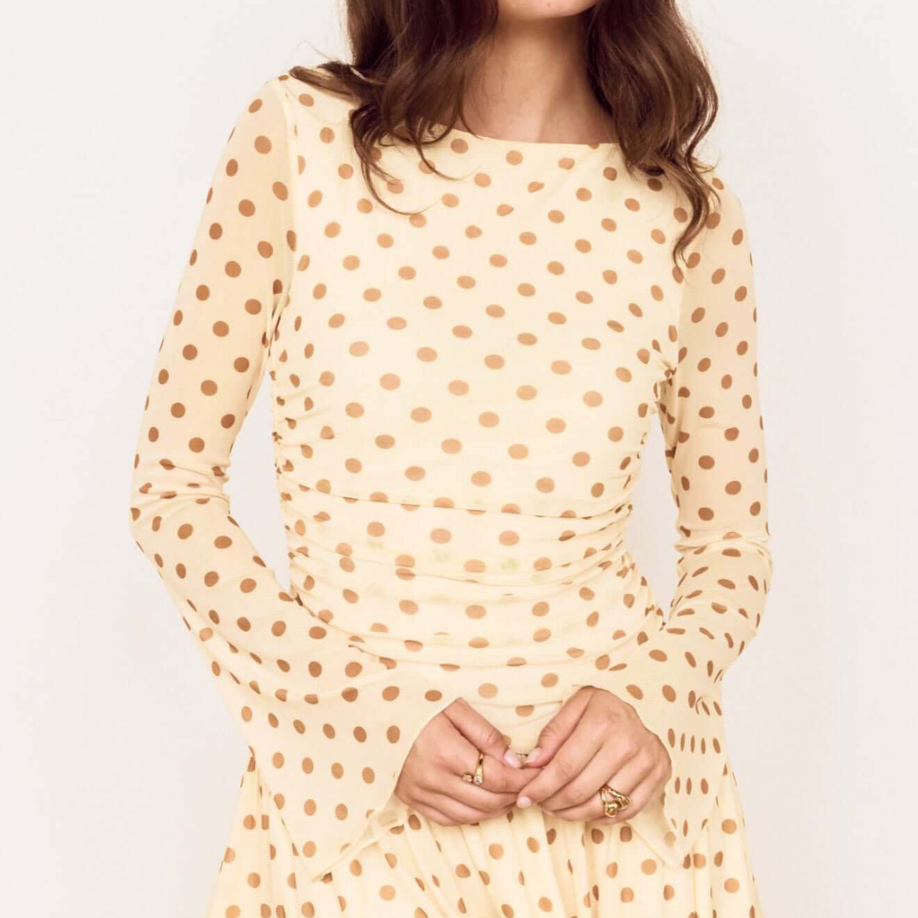 Butter Yellow Polka Dot Mini Dress with Drop Waist, showcasing a playful design and flattering silhouette.