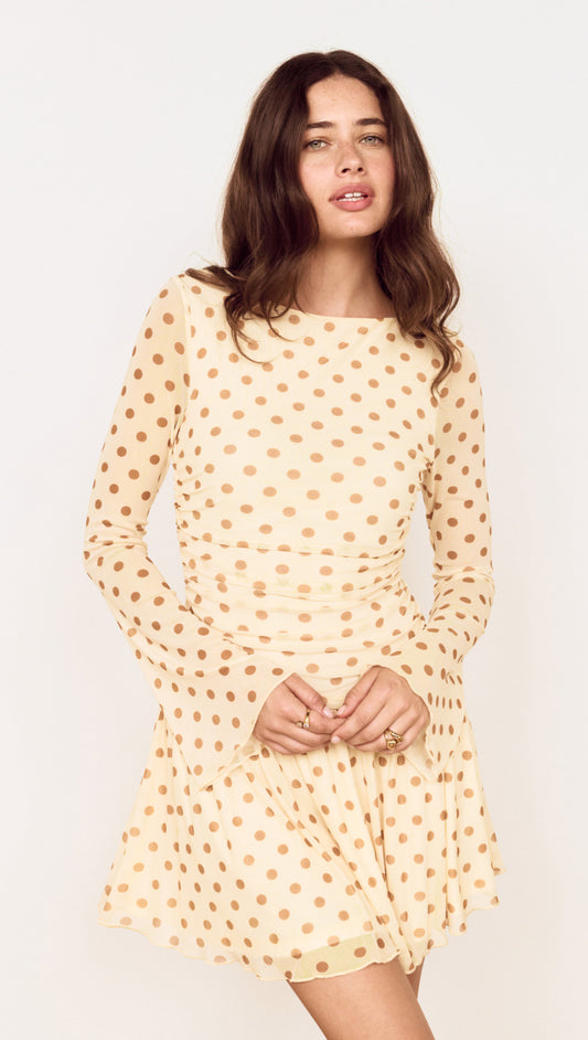 Butter Yellow Polka Dot Mini Dress with Drop Waist, showcasing a playful design and flattering silhouette.
