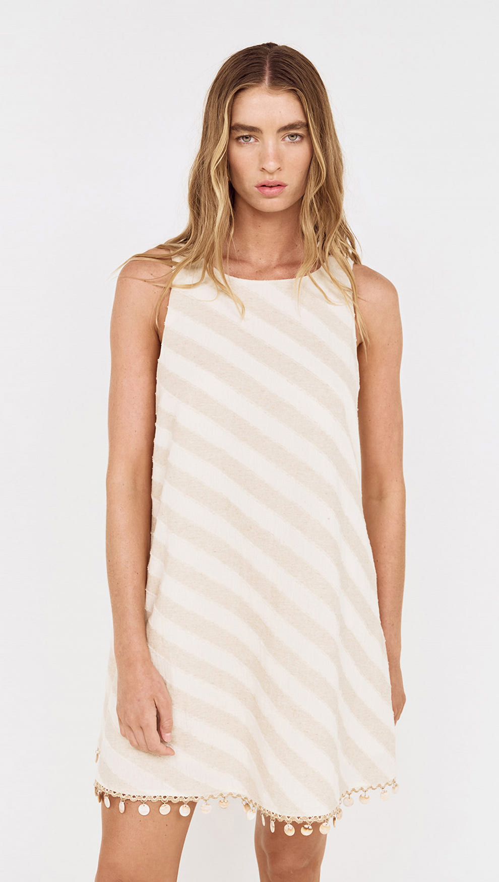 Cotton Linen Blend Mini Dress with Shell Detail worn by a model in a light striped pattern.
