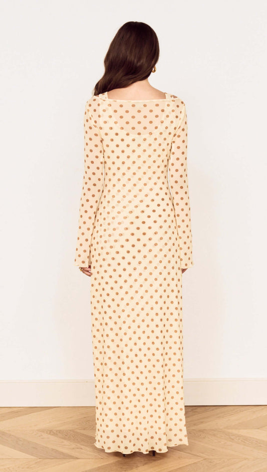 Back view of the Butter Yellow Polka Dot Midi Dress showcasing its layered design and flared sleeves.