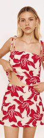 Cotton A-Line Mini Skirt in Red Floral worn with matching top, featuring a bold red floral print on a light background.