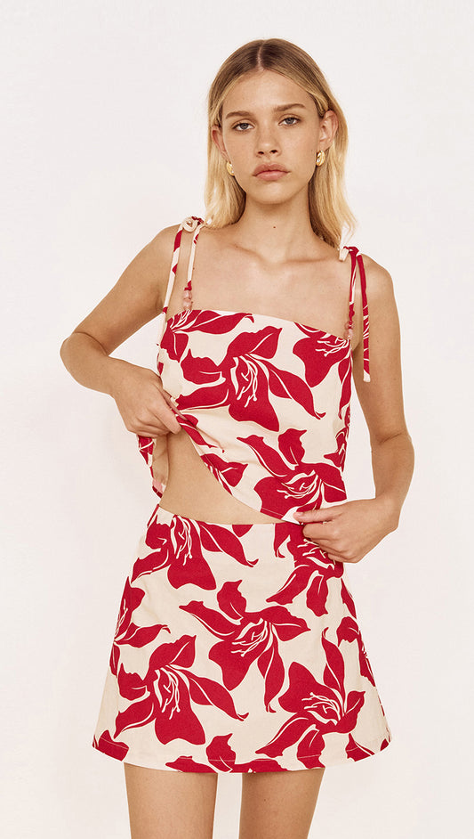Cotton A-Line Mini Skirt in Red Floral worn with matching top, featuring a bold red floral print on a light background.