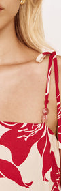 Close-up of the Red Floral Cotton Top with Tie Detail showcasing the adjustable beaded straps.