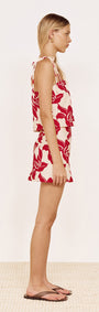 Model wearing Cotton A-Line Mini Skirt in Red Floral with matching top, showcasing the side view.
