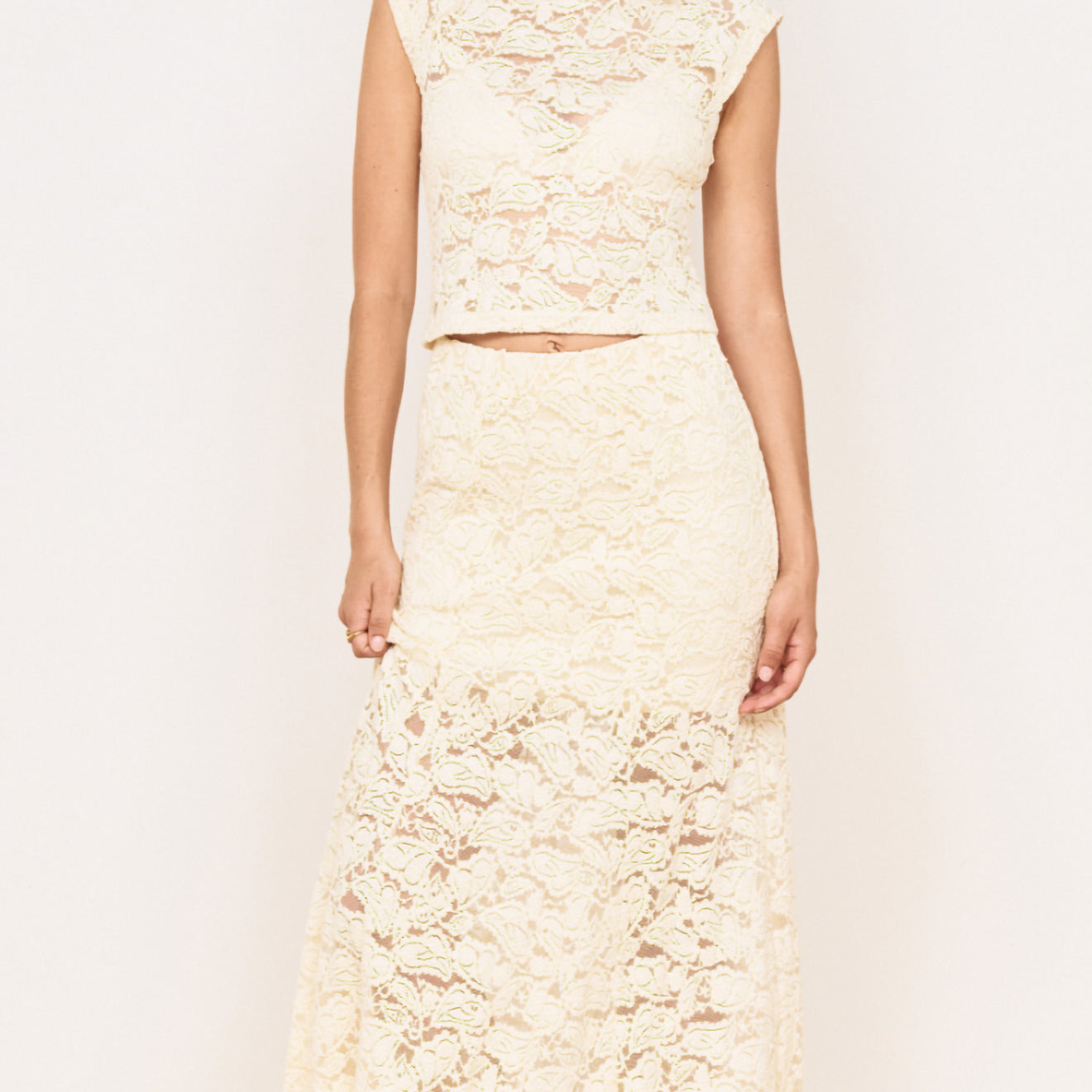 Model wearing Cream Cotton Lace Maxi Skirt with matching lace top in a stylish pose, showcasing elegant floral lace design.