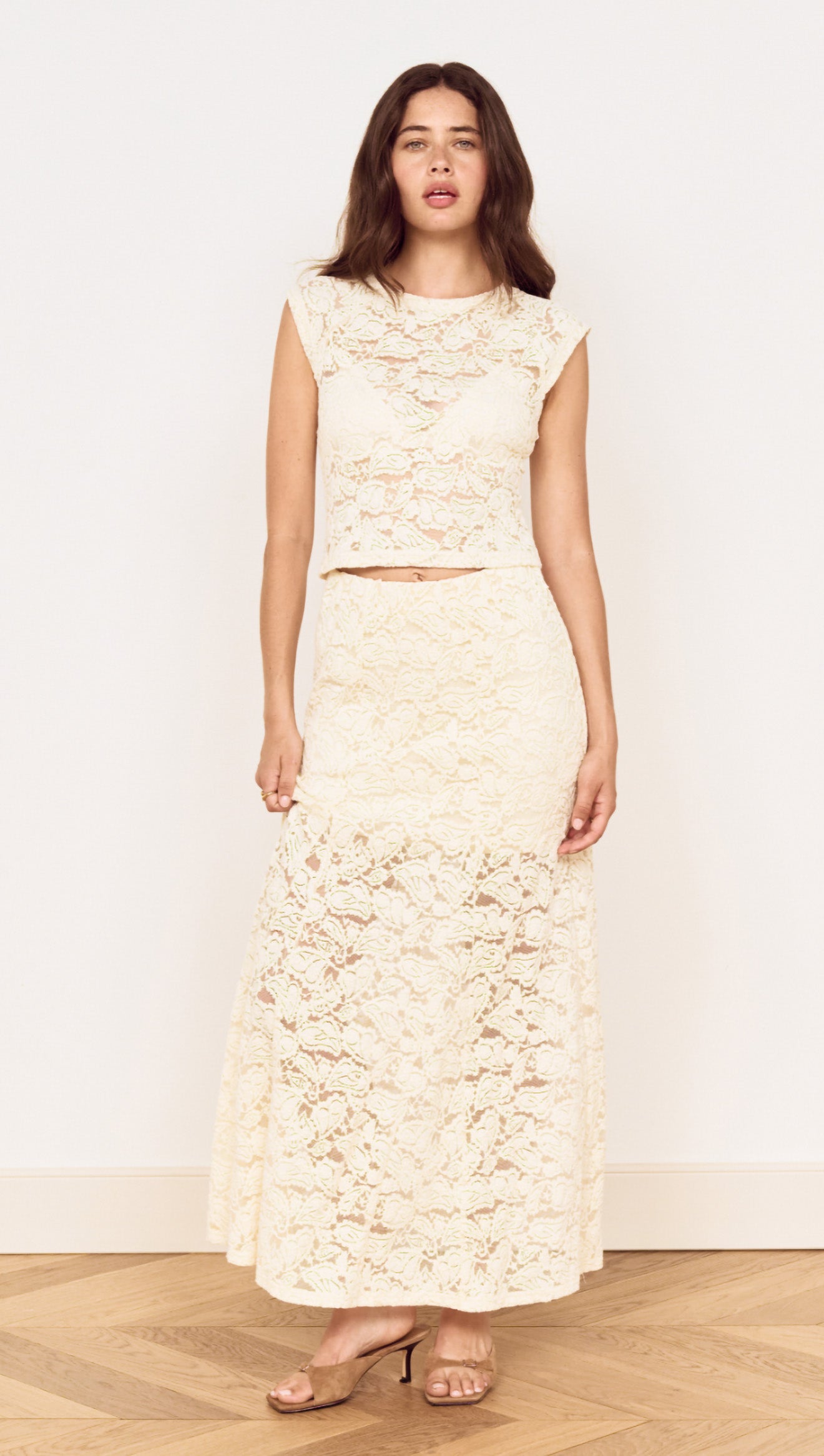 Model wearing Cream Cotton Lace Maxi Skirt with matching lace top in a stylish pose, showcasing elegant floral lace design.