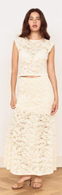 Model wearing Cream Cotton Lace Maxi Skirt with matching lace top in a stylish pose, showcasing elegant floral lace design.