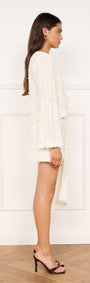 Sash Detail Sequin Mini Skirt in Cream showcased in a side view with draped sash detailing.