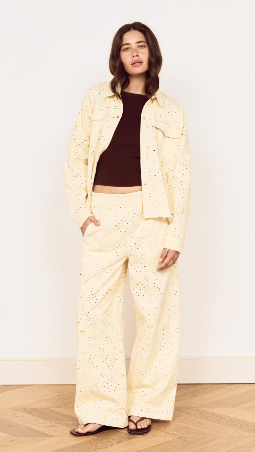 Cotton Denim Broderie Anglaise Jacket worn with matching bottoms, featuring delicate broderie detailing.