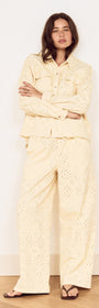 Model wearing a Cotton Denim Broderie Anglaise Jacket with matching bottoms, showcasing broderie cutwork design.