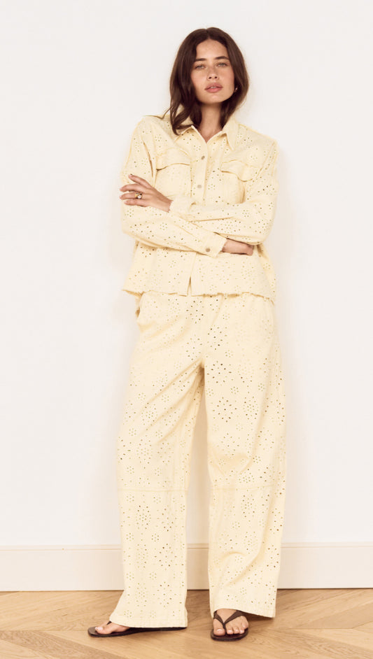 Model wearing a Cotton Denim Broderie Anglaise Jacket with matching bottoms, showcasing broderie cutwork design.