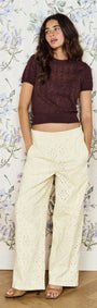 Relaxed Fit Cotton Denim Broderie Pant worn with a crop top in a vintage floral backdrop.