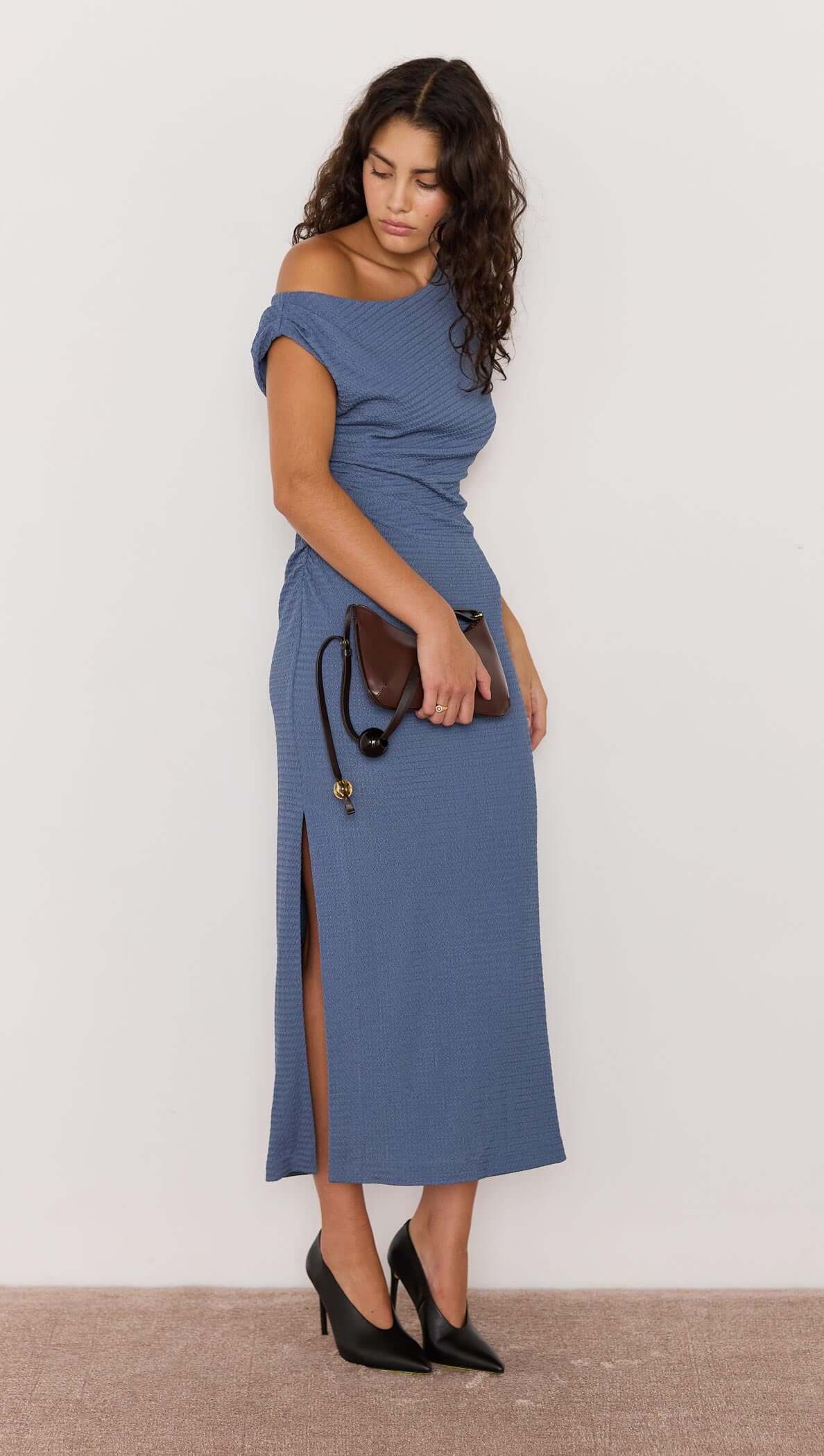 Model wearing the Freya Asymmetrical Dress in slate blue, showcasing a one-shoulder neckline and side ruching.