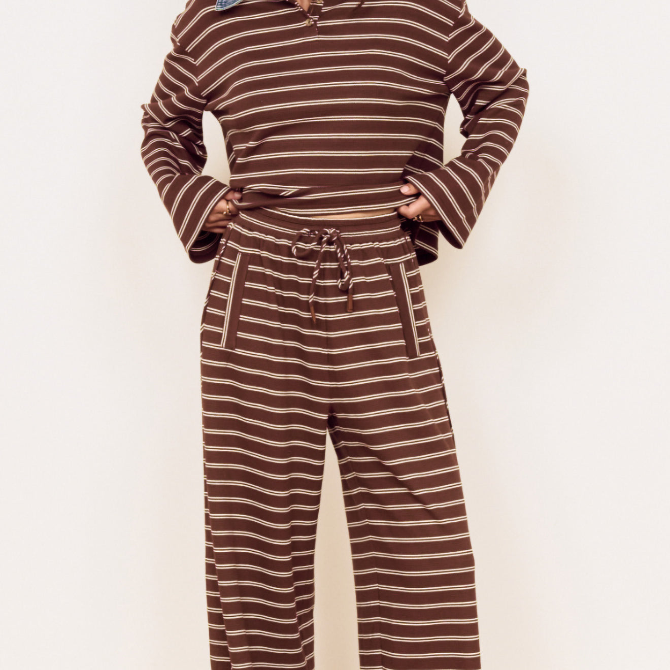 Model wearing Stripe Relaxed Drawstring Jersey Pant with vintage chocolate stripes and a relaxed fit.